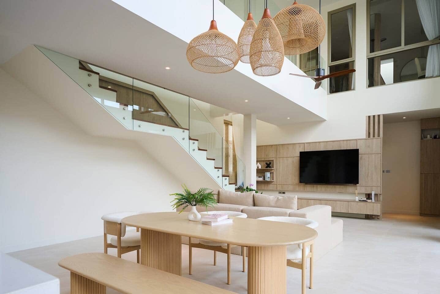 Dining area under rattan pendant lights at Villa Belcasa