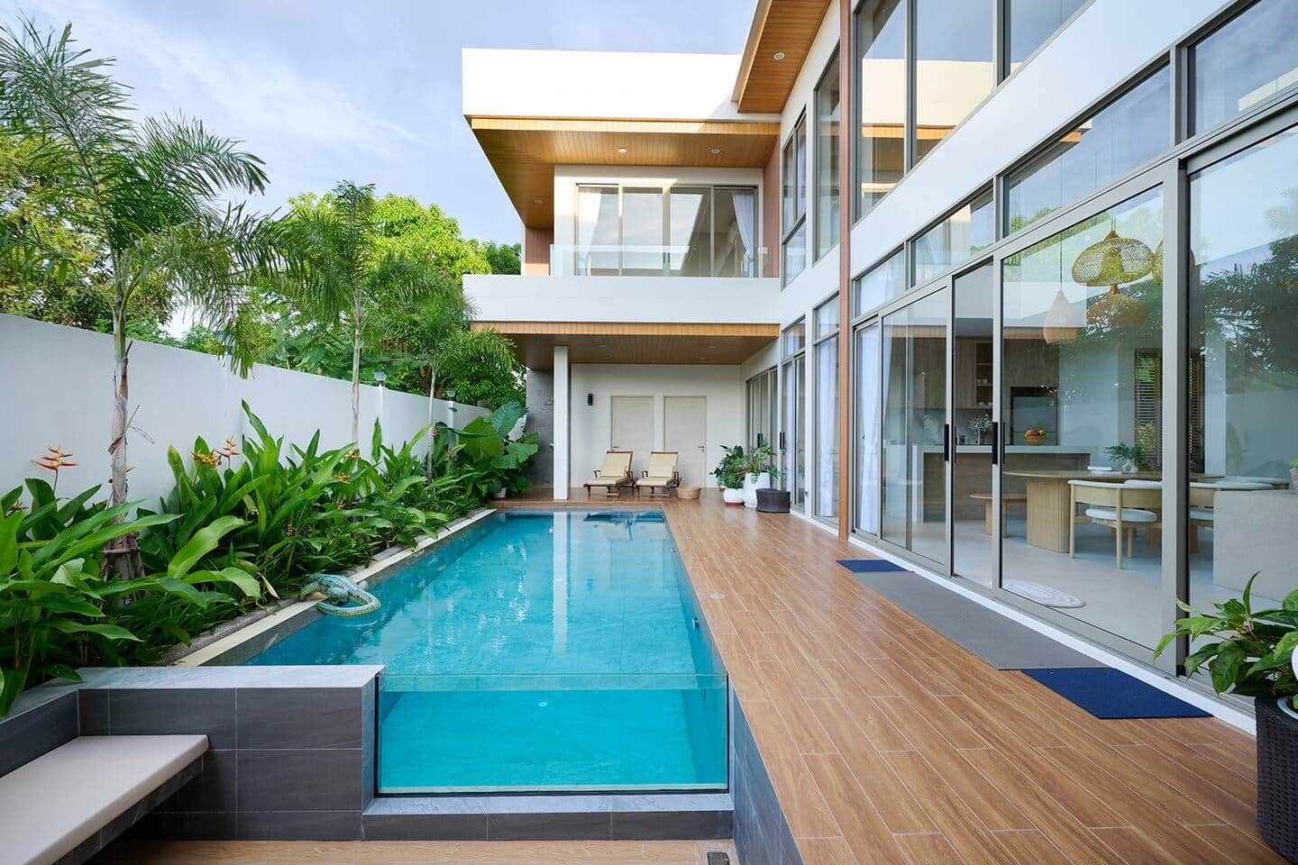 Pool deck along the villa's glass wall