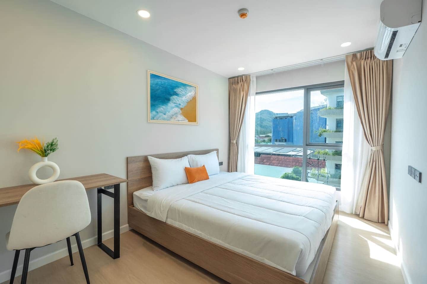 Master bedroom with desk and soft curtains