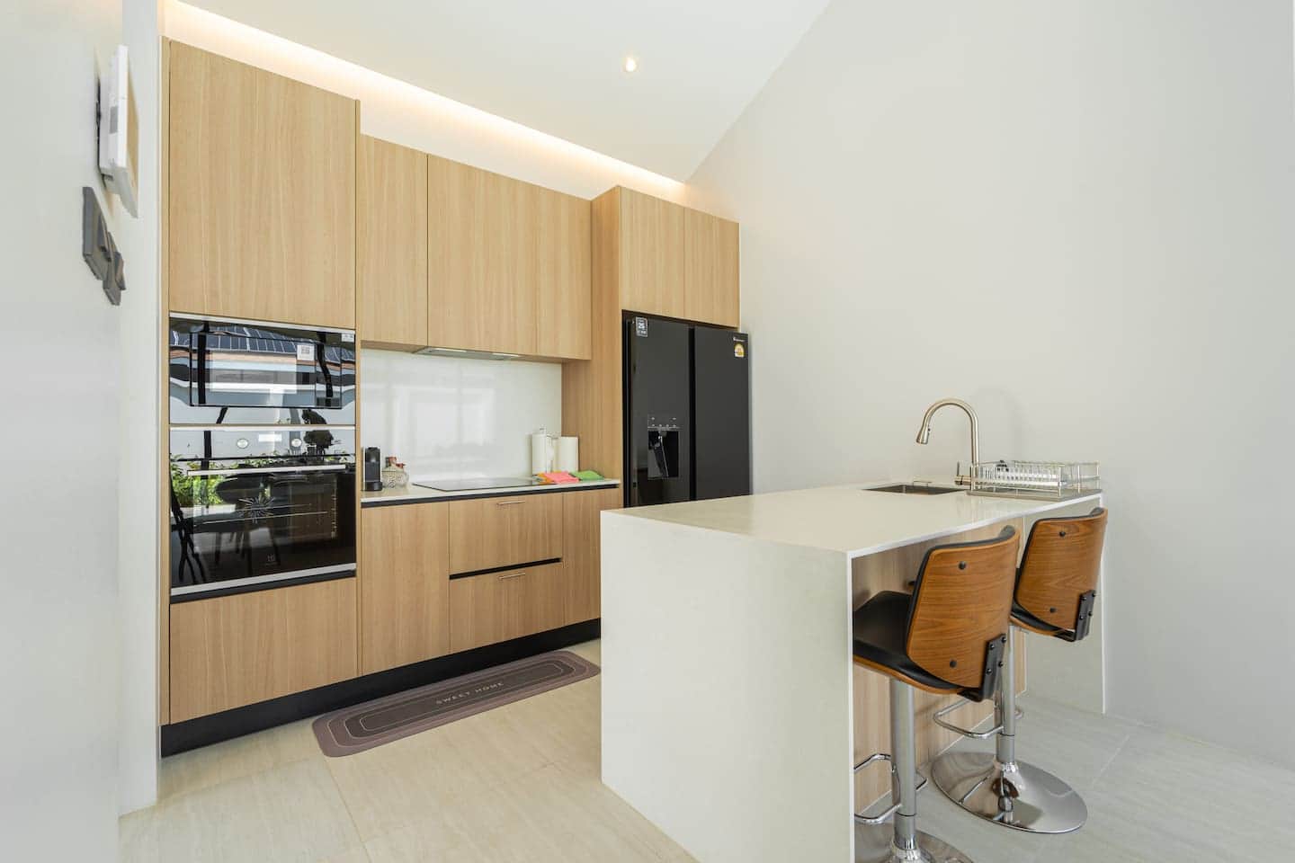 Kitchen with island and full-height fridge at Villa Belplaya
